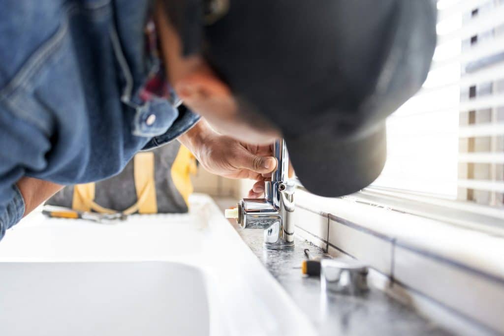 trusted Residential Plumbing and Emergency Services in Northeast Indiana | Plumber fixing faucet, plumbing and maintenance with man, manual labour and home renovation with tr